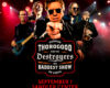 Concert poster featuring George Thorogood and the Destroyers performing on stage with a bold logo in the center and red lighting behind them.