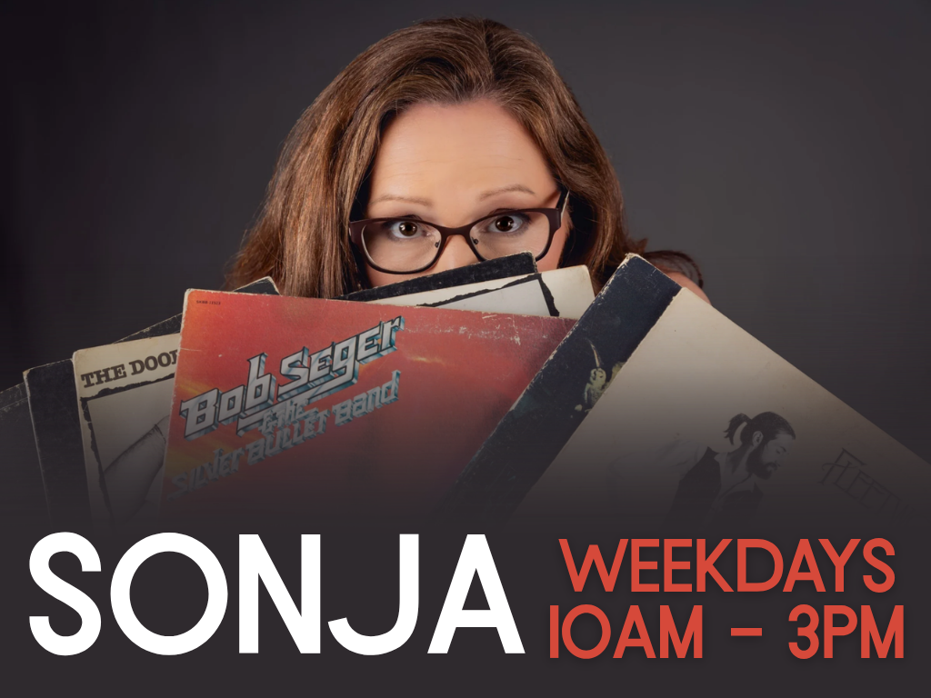 Woman with glasses peeks over a stack of vinyl records; promotional banner for Sonja's show, weekdays 10AM–3PM.
